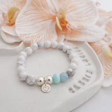 Load image into Gallery viewer, 925 Sterling Silver Howlite Peruvian Opal and aquamarine 8mm Handmade Crystal Bracelet on a jewellery dish with peach orchids - Proudly Supporting Sea Shepherd
