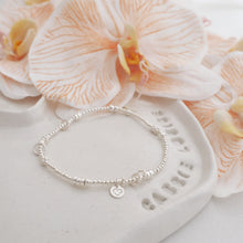 Load image into Gallery viewer, QUI E ORA - 925 Sterling Silver 4mm Handmade Bracelet on a jewellery dish with peach orchids HERE AND NOW 2
